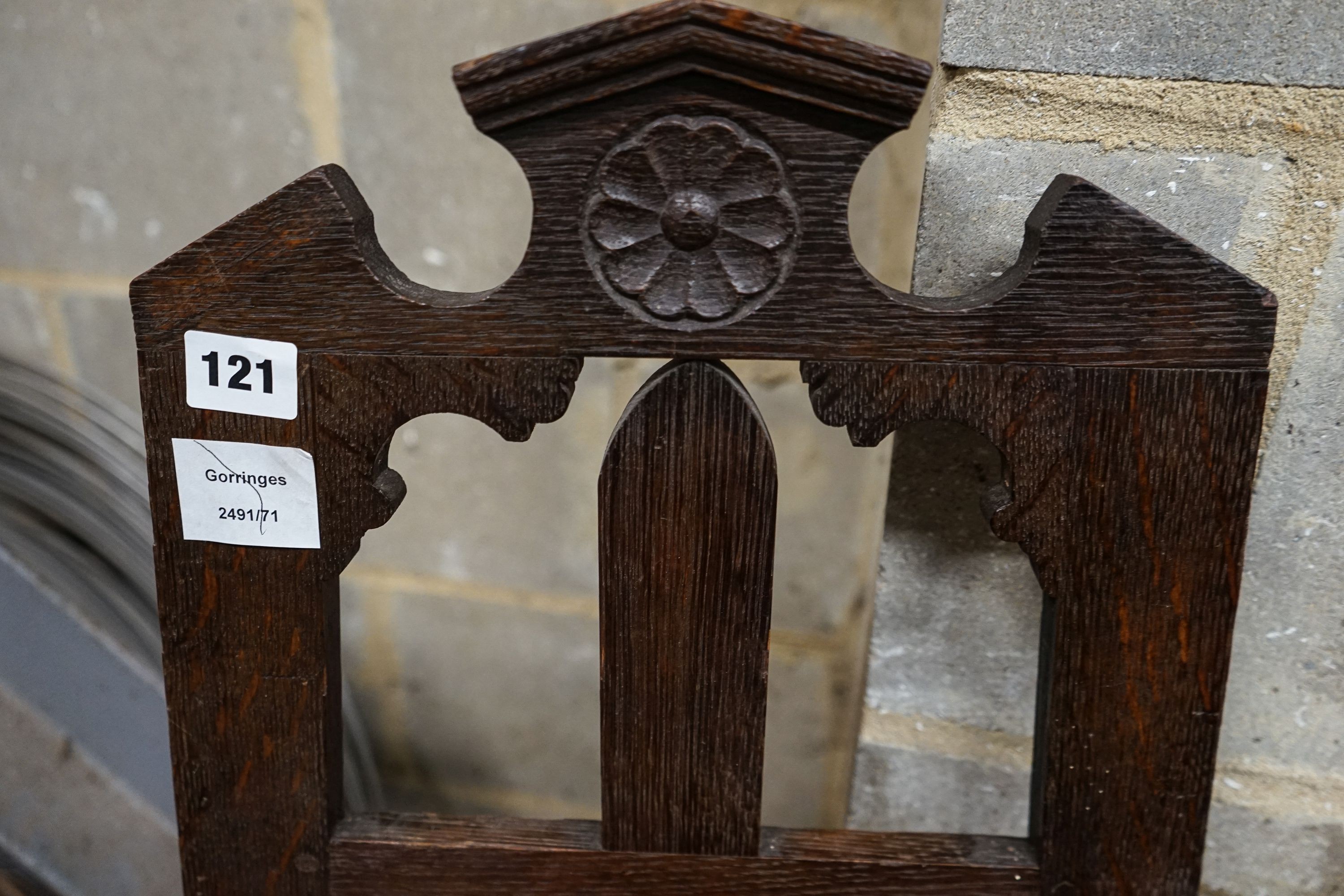 A late Victorian oak easel, with floral carved decoration, width 33cm, height 117cm